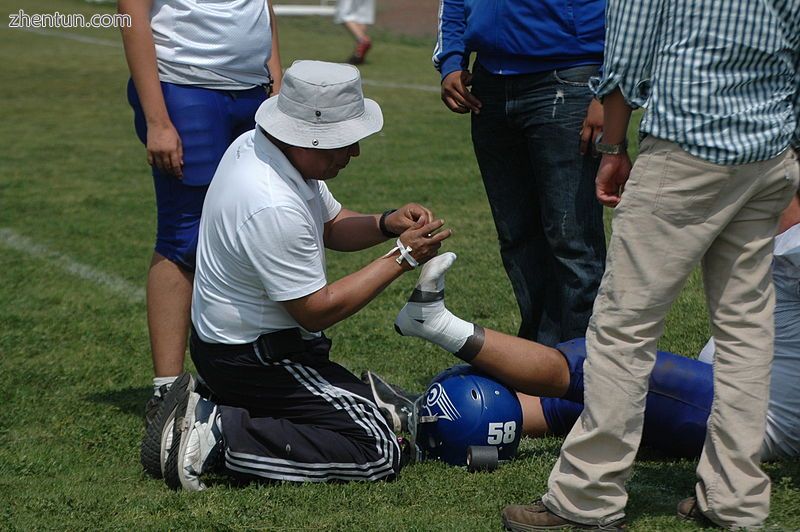 Player getting ankle taped at an American football game in Mexico.jpg