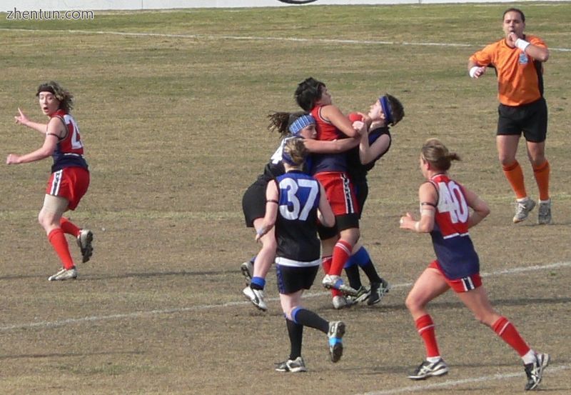 Tackles like this one in women&#039;s Australian rules football can cause injuries..jpg