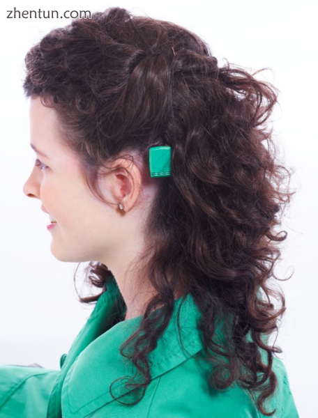 A hearing-aid user with a sound processor attached behind her ear.PNG