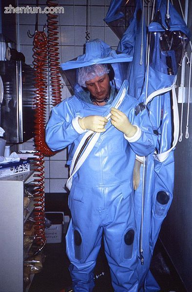 CDC technician dons an older-model positive-pressure suit before entering one of.jpg