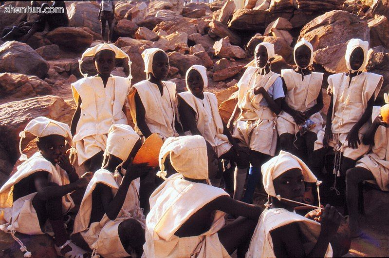 Boys in white clothing with bonnets at Tireli market, just after circumcision, Mali 1990