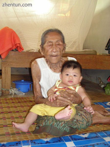 95-year-old woman holding a five-month-old boy