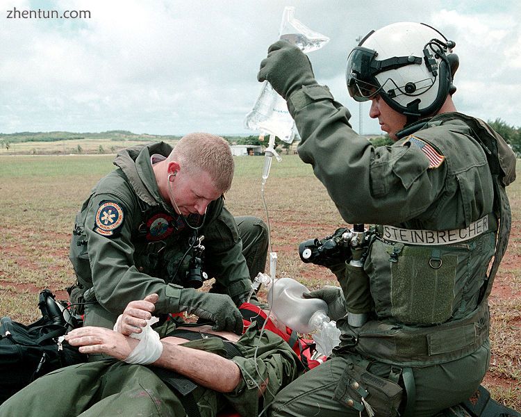 A Navy corpsmen listens for the correct tube placement on an intubated trauma vi.jpg