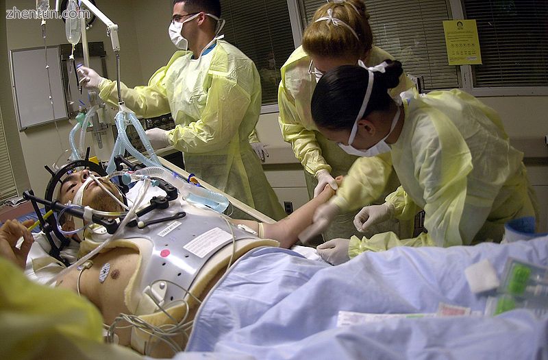 Health care providers attending to a person on a stretcher with a gunshot wound .jpg