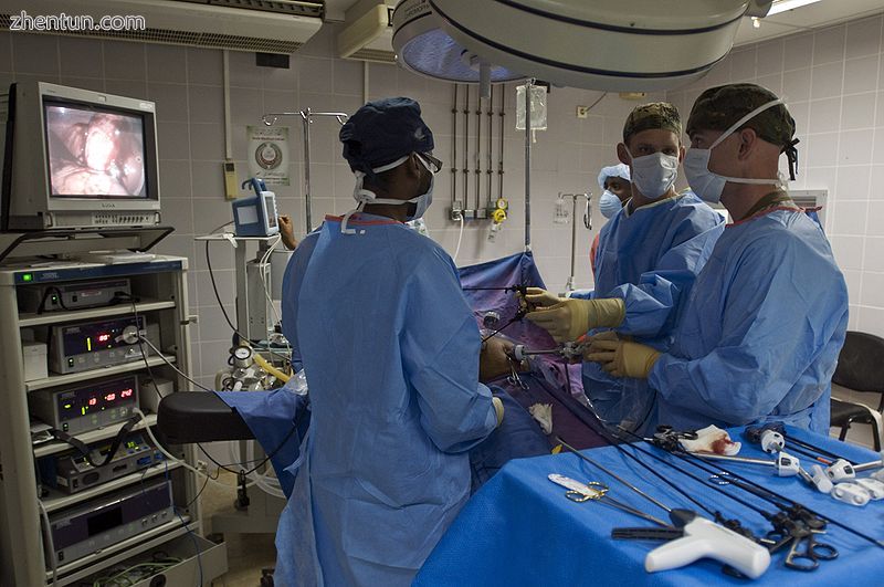 A US Navy general surgeon and an operating room nurse performing a laparoscopic .jpg