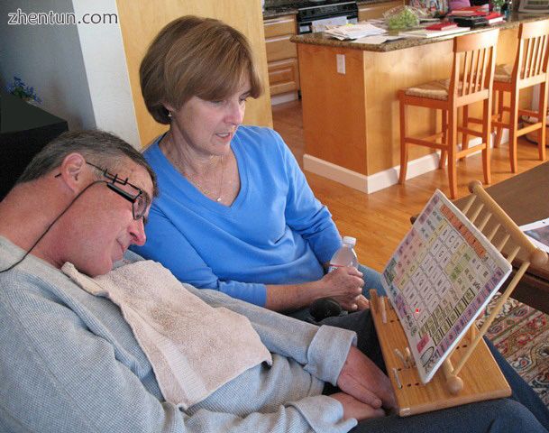 A man with ALS communicates by pointing to letters and words using a head mounte.jpg